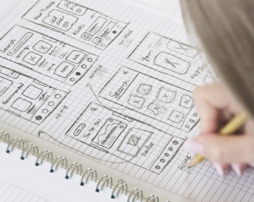Nahaufnahme mehrerer gescribbelter Mock-Ups in einem Notizbuch